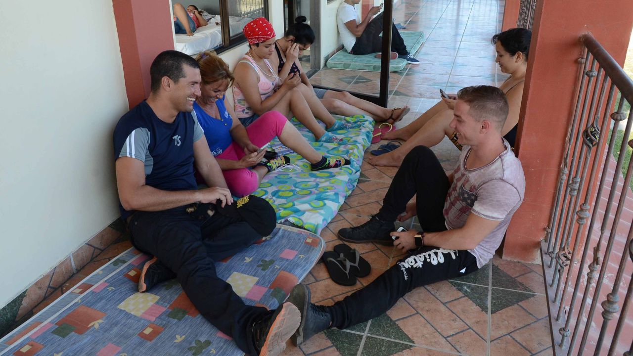 Cubans rest at a Methodist church sheltering 35 Cuban refugees in Liberia, Guanacaste, Costa Rica, on December 29, 2015. Costa Rica on Tuesday warned it should not be seen as an "open bridge" to America after striking a deal to start shipping out stranded Cuban migrants to other Central American countries. AFP PHOTO/Carlos GONZALEZ / AFP / CARLOS GONZALEZ