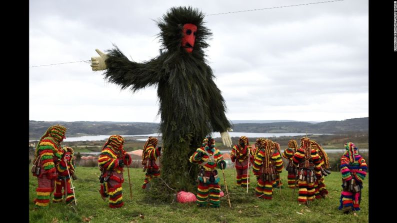 Participantes disfrazados se reúnen alrededor de un muñeco gigante durante las celebraciones del carnaval en Podence, Portugal, el domingo 7 de febrero.