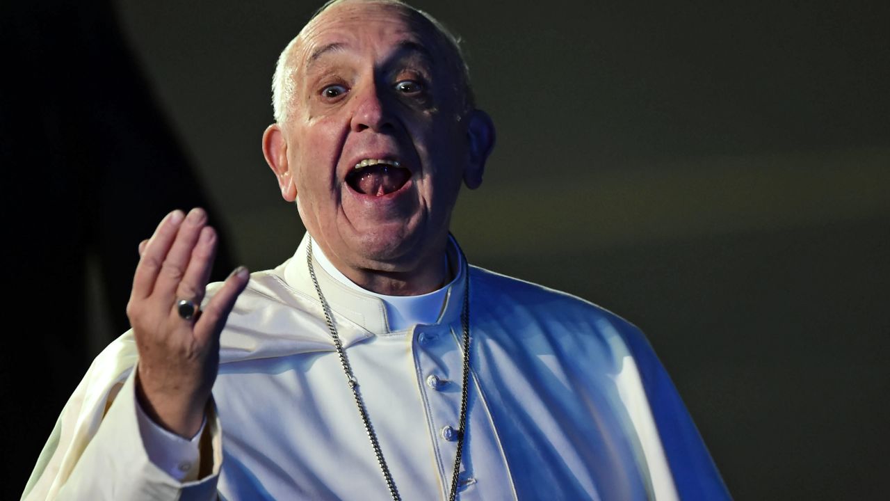 Pope Francis gestures upon his arrival at Benito Juarez international airport in Mexico City on February 12, 2016. Catholic faithful flocked to the streets of Mexico City to greet Pope Francis on Friday after the pontiff held a historic meeting with the head of the Russian Orthodox Church in Cuba. AFP PHOTO/RONALDO SCHEMIDT / AFP / RONALDO SCHEMIDT