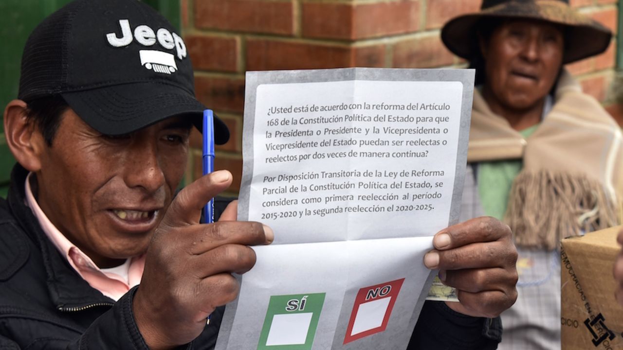 An election judge shows the ballot to a voter on February 21, 2016 in Huarina, 75 km from La Paz, Bolivia during a referendum on a constitutional reform that would allow Evo Morales to seek a fourth term as president, potentially extending his stay in office until 2025. Morales, Bolivia's first indigenous president, was first elected to office in 2006 and re-elected twice. His current term ends in 2020. AFP PHOTO/Aizar Raldes / AFP / AIZAR RALDES