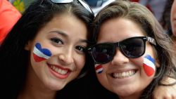 Costa Rican fans smile as they watch the Brazil 2014 FIFA World Cup football match against England in a giant screen at Democracy Square in San Jose on June 24, 2014. Costa Rica drew 0-0 with England to top World Cup Group D unbeaten and leave their opponents winless and bottom of the table on Tuesday in Belo Horizonte.  AFP PHOTO/Ezequiel BECERRA