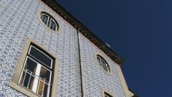 LISBON, PORTUGAL - JULY 23: A building covered in typical tiles of the region stands on July 23, 2008 in Lisbon, Portugal. Portugal is becoming an increasingly popular tourist destination.