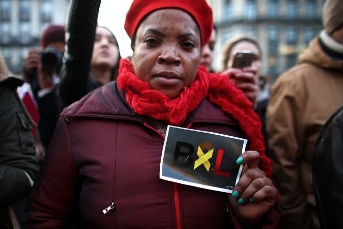 Una mujer sostiene un papel con las letras BXL (Bruxelles, como se escribe Bruselas en francés) como muestra de su solidaridad con las víctimas de los ataques de ISIS.