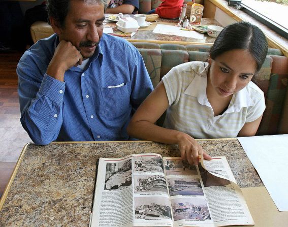 La mexicana Juana Jazmin Arias (D), sobreviviente del terremoto del 19 de setiembre de 1985, muestra, junto a su padre Miguel Angel Arias, una revista con fotos del desastre, el 15 de setiembre de 2005 en Ciudad de Mexico. Arias, al igual que otros 13 jóvenes mexicanos, fueron rescatados de los escombros tras el sismo. Juana Jazmin Arias fue la primera de los 14 bebés.