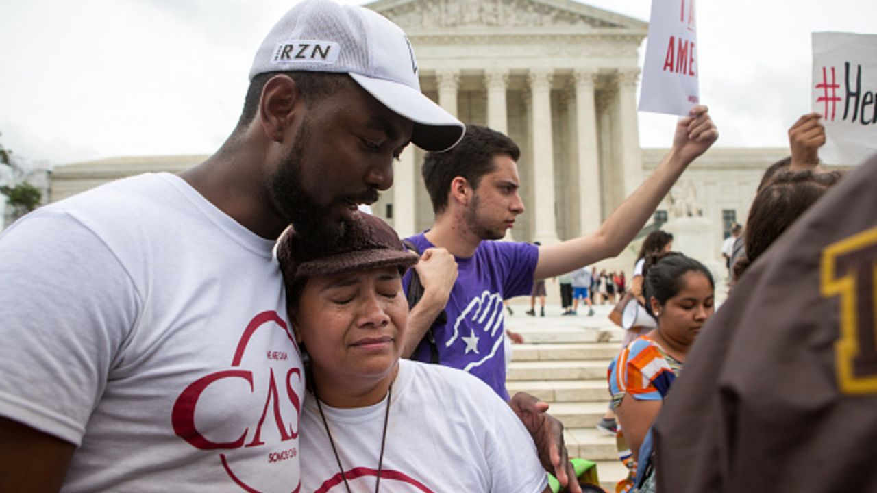 WASHINGTON, DC - JUNE 23: Rosario Reyes, an undocumented mother from El Salvador, reacts to news on a Supreme Court decision blocking Obama's immigration plan, which would have protected millions of immigrants from deportation, in front of the U.S. Supreme Court, on June 23, 2016 in Washington, DC.  The court was divided 4-4, leaving in place an appeals court ruling blocking the plan.