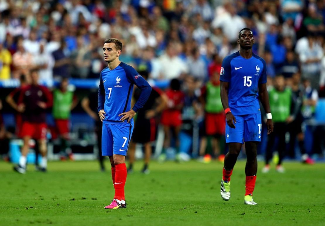 PARIS, FRANCE - JULY 10: Antoine Griezmann and Paul Pogba of France show their dejection after the final whistle of the UEFA EURO 2016 Final match between Portugal and France at Stade de France on July 10, 2016 in Paris, France.