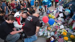 Mourners visit the Police Headquarters memorial for officers killed in the recent sniper attack in Dallas, Texas on July 10, 2016.
The gunman who opened fire on Dallas officers during a protest against US police brutality, leaving five dead and seven others wounded, told negotiators he wanted to kill white cops, the city's police chief said July 8. / AFP / Laura Buckman