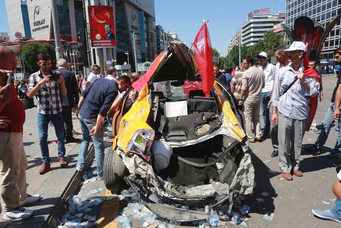 Destrozos. Varias personas observan los daños causados a vehículos en la intentona golpista en Turquía.