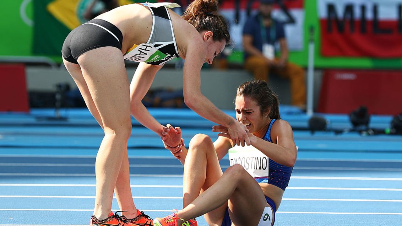 RIO DE JANEIRO, BRAZIL - AUGUST 16:  Abbey D'Agostino of the United States (R) is assisted by Nikki Hamblin of New Zealand after a collision during the Women's 5000m Round 1 - Heat 2 on Day 11 of the Rio 2016 Olympic Games at the Olympic Stadium on August 16, 2016 in Rio de Janeiro, Brazil.