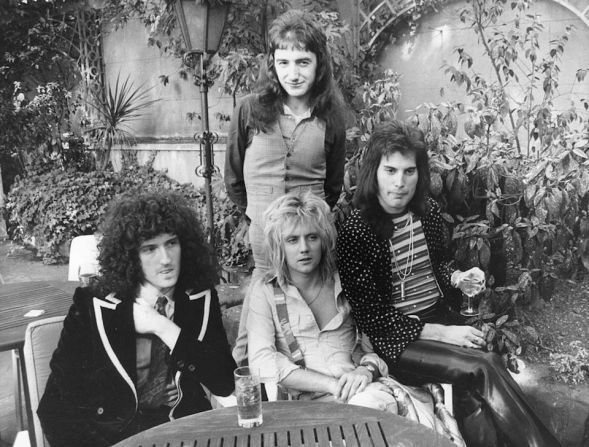 Los integrantes de Queen en 1976, de izquierda a derecha: Brian May, John Deacon (de pie), Roger Taylor y Freddie Mercury.