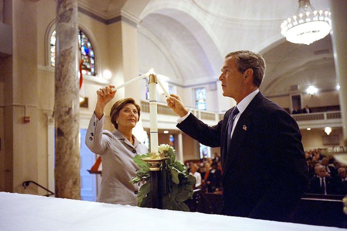 WASHINGTON, DC - SEPTEMBER 11:  President George W. Bush and First Lady Laura Bush light a candle at St. John Episcopal Church in Washington, D.C., during a private service of prayer and remembrance the morning of 11 September 2002. Bush dedicated all of September 11 to remembrances of the attacks in a tour of the three crash sites including the Pentagon outside Washington, Shanksville in the eastern US state of Pennsylvania and New York City.AFP PHOTO/POOL/Eric DRAPER