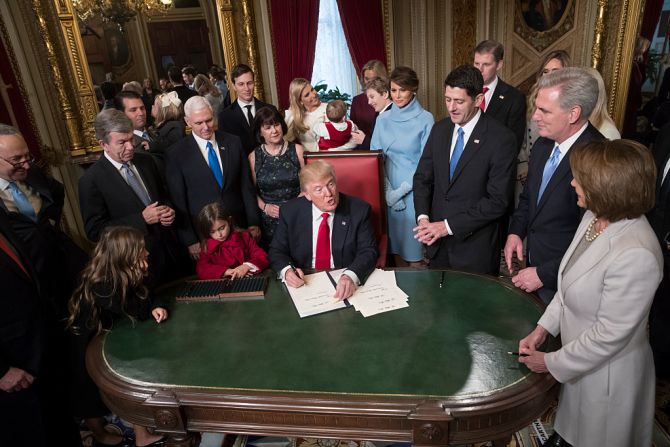 El presidente Donald Trump acompañado de los líderes del Congreso y su familia mientras firma oficialmente sus nominaciones al gabinete en la Sala Presidencial del Senado del Capitolio.