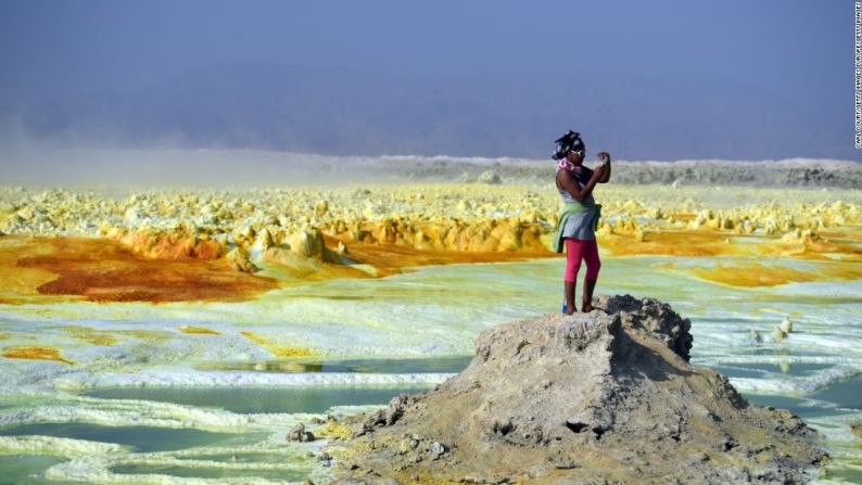 Amantes de la adrenalina — Un turista toma fotos del paisaje. A pesar de las brutales condiciones, Dankil se está volviendo un destino de vacaciones cada vez más popular.