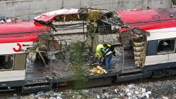 Forensic experts inspect the trains which exploded at the Atocha train station the day before, 12 March 2004 in Madrid. At least 198 people were killed and more than 1400 wounded in bomb attacks on four commuter trains, 11 March 2004.