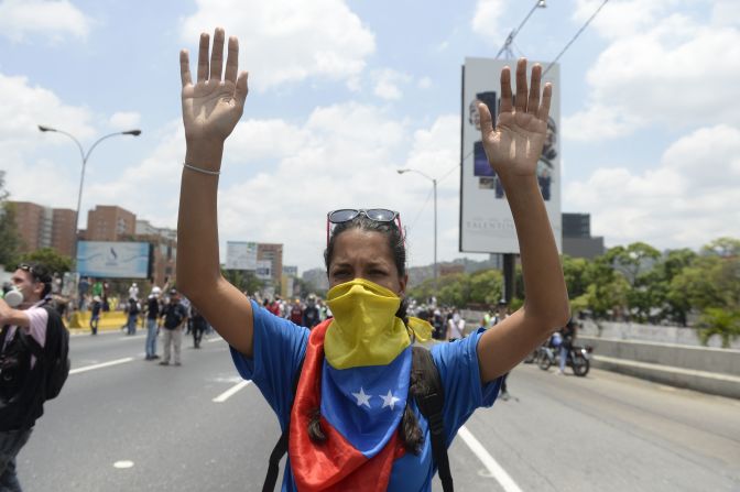 Una de las manifestantes del #10A alza las manos ante la Guardia Nacional Bolivarania.