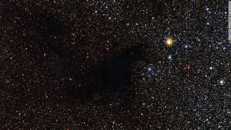 Un parche de estrellas parece faltar en esta imagen del Observatorio de La Silla en Chile. Pero las estrellas están ahí detrás de una nube de gas y polvo llamada Lynds Dark Nebula 483. La nube está a unos 700 años luz de la Tierra en la constelación Serpens.