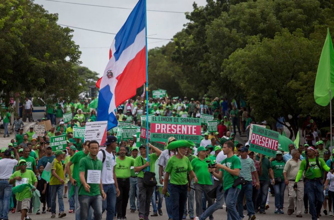 Manifestantes izan la bandera dominicana durante el evento de la Marcha Verde en Santo Domingo.