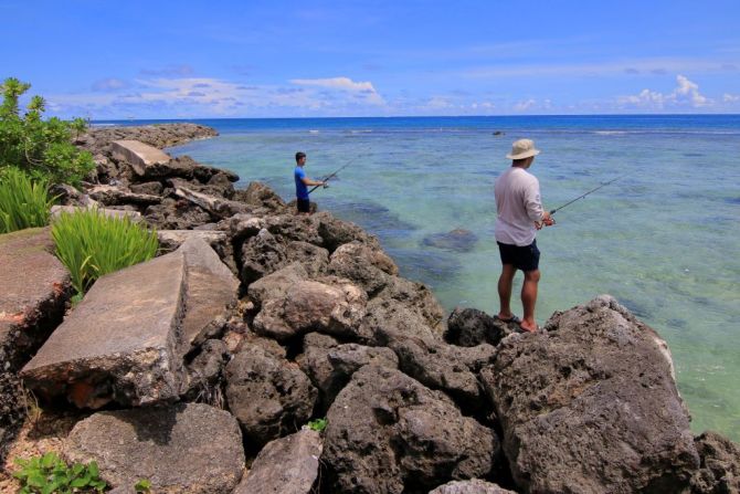 Los residentes pescan cerca de la playa de Tumon.