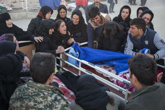 Los familiares de una víctima lloran sobre su cadáver tras el terremoto en Sarpol-e Zahab.