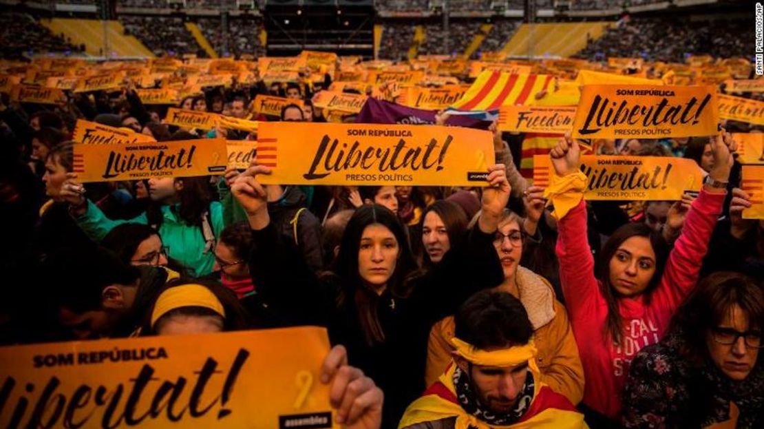 Un grupo de asistentes a un concierto para apoyar la libertad de los líderes catalanes sostienen carteles pidiendo la libertad de los “presos políticos”.