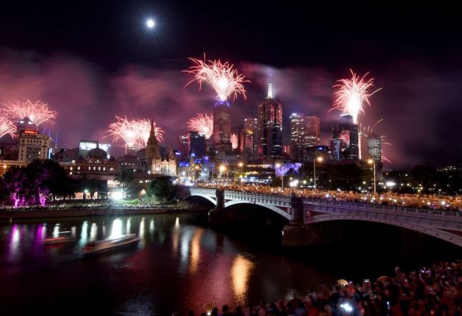 Fuegos artificiales iluminan el cielo sobre los edificios junto al río Yarra en Melbourne, Australia.