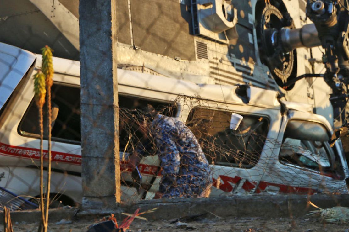 Un soldado observa los restos del helicóptero que cayó sobre vehículos con pasajeros en Santiago Jamiltepec, en México.