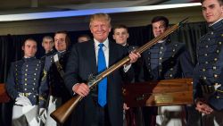 CHARLESTON, SC - FEBRUARY 22: Reality TV host and New York real estate mogul Donald Trump holds up a replica flintlock rifle awarded him by cadets during the Republican Society Patriot Dinner at the Citadel Military College on February 22, 2015 in Charleston, South Carolina. Trump and U.S. Sen. Tim Scott (R-SC) were honored at the annual event.