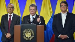 El presidente de Colombia, Juan Manuel Santos (centro), hablando junto al comisionado de paz, Rodrigo Rivera (izquierda) y Gustavo Bell (derecha) en marzo de 2018, cuando ordenó a los negociadores del gobierno que reanuden las conversaciones con el último grupo rebelde activo del país sudamericano, el Ejército de Liberación Nacional (ELN).