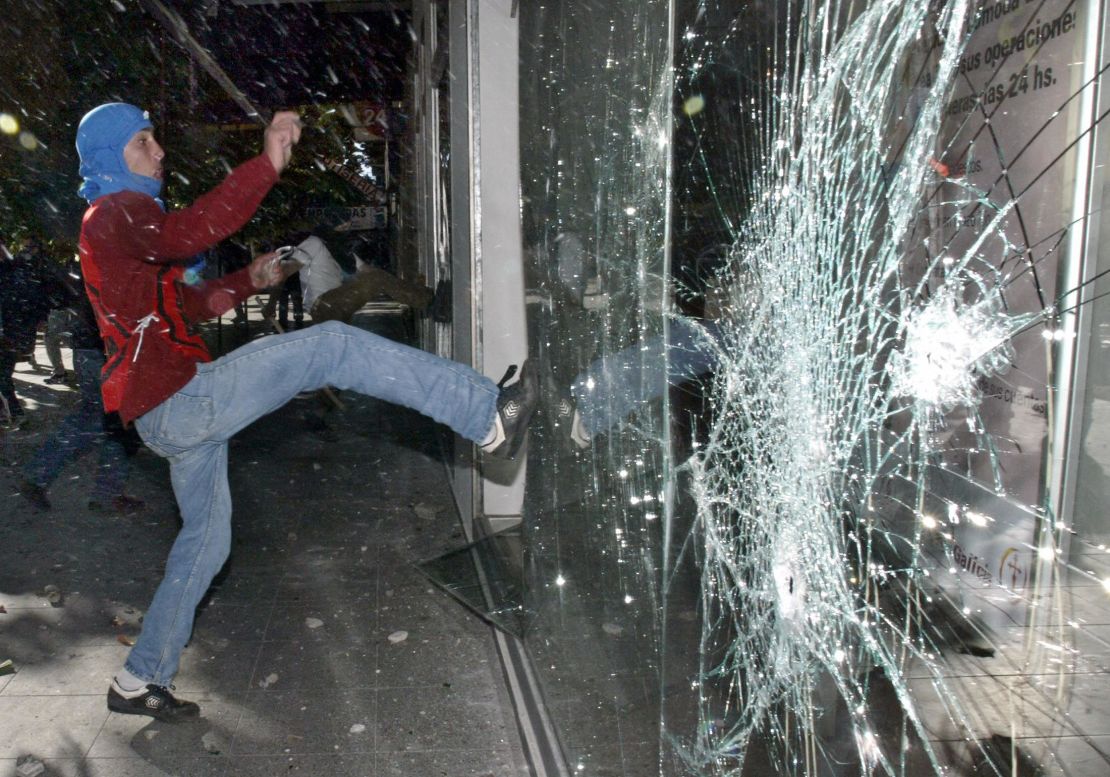 Un manifestante rompe el cristal de un comercio durante la manifestación en Mar del Plata, Argentina, contra George W. Bush en la Cumbre de las Américas de 2005.