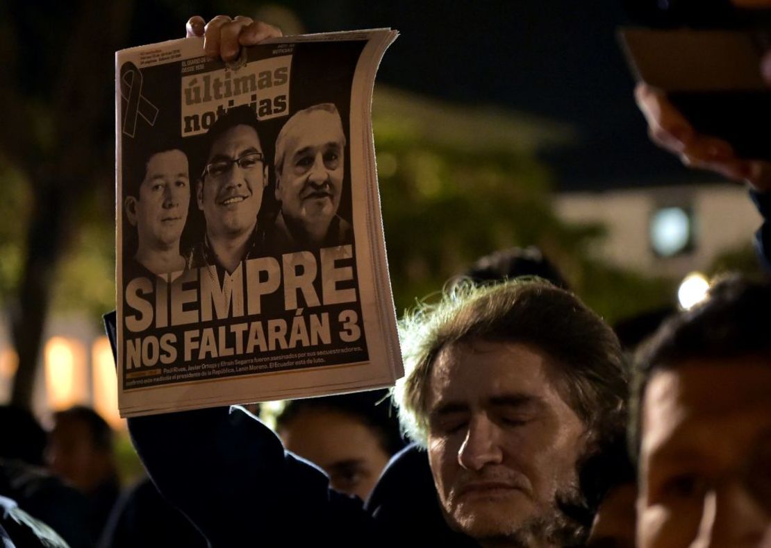 Quito, Ecuador — Un hombre sostiene un diario en cuya portada aparecen los periodistas ecuatorianos asesinados por disidentes de las FARC, durante un homenaje que se les rindió frente a la Catedral Metropolitana en Quito, el 13 de abril de 2018.