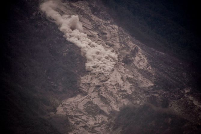 Humo sale de las laderas cubiertas de ceniza en San Miguel Los Lotes, Guatemala.