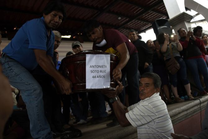 El ataúd con el cuerpo de una mujer de 64 años es llevado camino a una procesión en Guatemala.