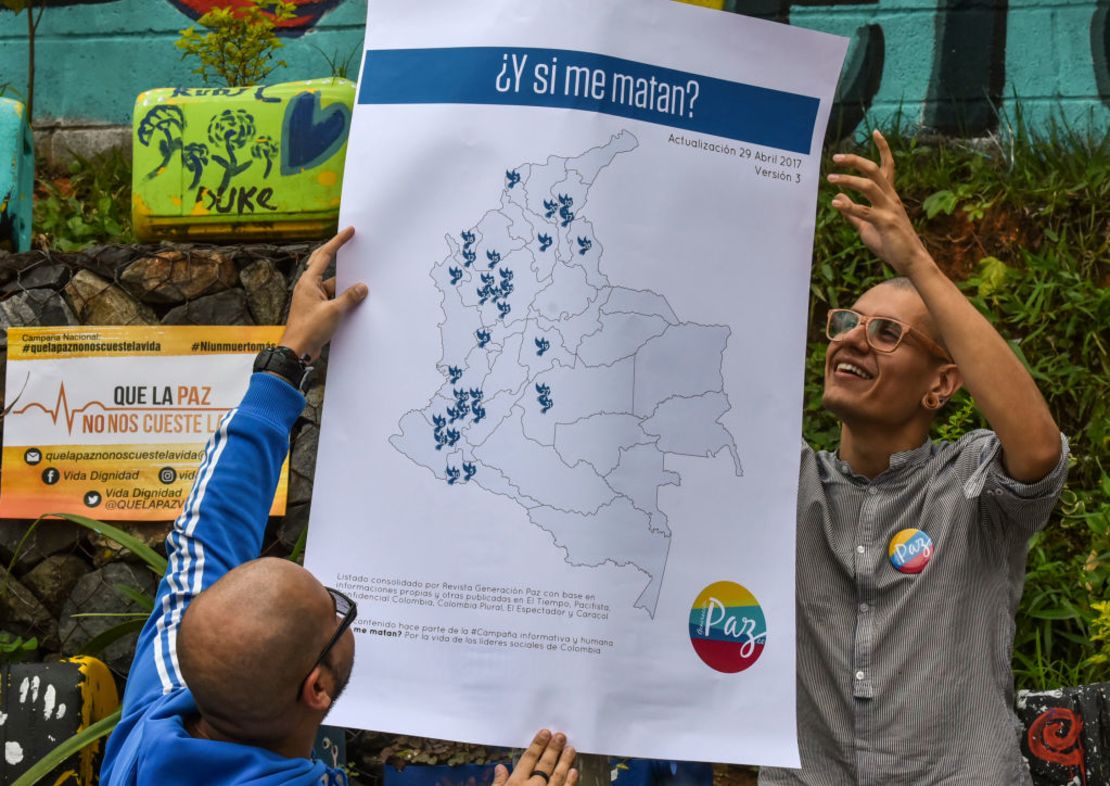 Dos hombres sostienen un mapa donde se han asesinado a líderes sociales después de la firma del acuerdo de paz, en una marcha en Medellín en mayo de 2017.