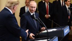 US President Donald Trump (L) and Russia's President Vladimir Putin shake hands during a joint press conference after a meeting at the Presidential Palace in Helsinki, on July 16, 2018. (Photo by Brendan SMIALOWSKI / AFP)