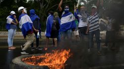 TOPSHOT - Students from different universities from across Nicaragua demand President Daniel Ortega and his powerful vice president, wife Rosario Murillo, to resign and the government to keep the 6% budget for universities, in Managua, on August 2, 2018. - The death toll in violent protests in Nicaragua against Ortega stands at 317, a US-based regional rights group said Thursday. (Photo by Marvin RECINOS / AFP)