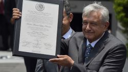 Mexican President-elect Andres Manuel Lopez Obrador shows a document after he was officially endorsed by the Federal Electoral Tribunal as the elected president in Mexico City on August 8, 2018. (Photo by ALFREDO ESTRELLA / AFP)