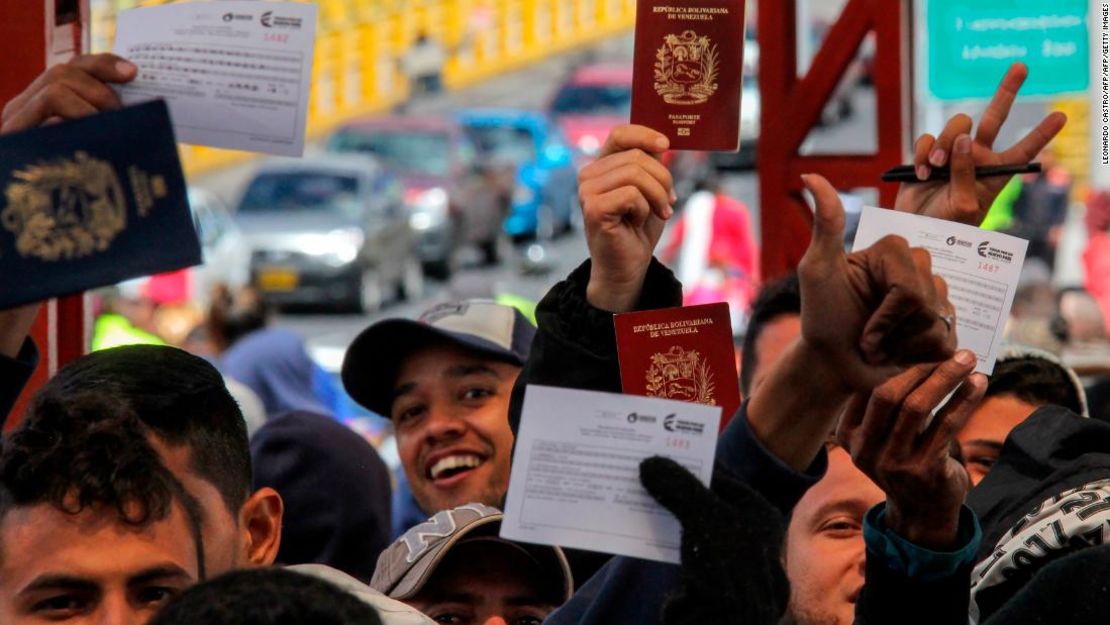 Un grupo de venezolanos esperan en fila para cruzar el puente Internacional Rumichaca en la frontera entre Colombia y Ecuador, el 11 de agosto de 2018.