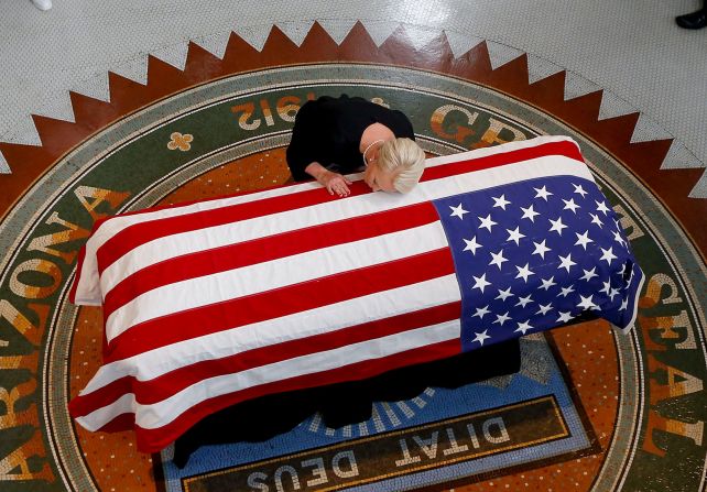 29 de agosto - Cindy McCain, la esposa del senador estadounidense John McCain, apoya la cabeza en el ataúd de su esposo durante un funeral en el Capitolio del Estado de Arizona. McCain murió la semana anterior a la edad de 81 años (Ross D. Franklin / The New York Times / Redux).