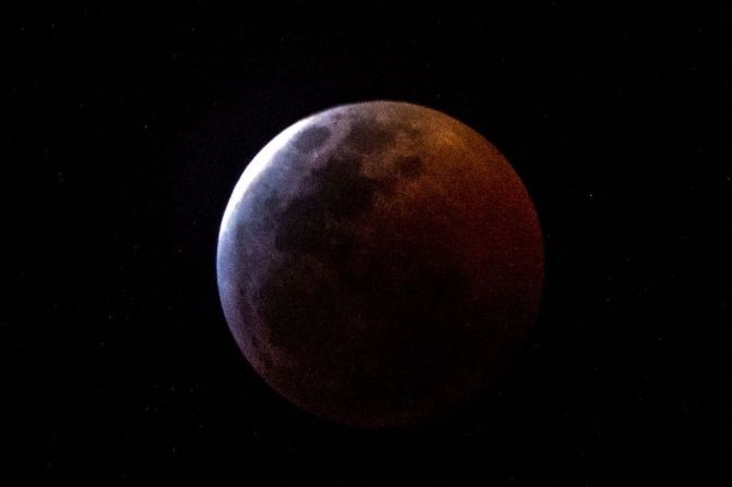 Earth's shadow almost totally obscures the view of the so-called Super Blood Wolf Moon during a total lunar eclipse, on Sunday January 20, 2019, in Miami, Florida. - The January 21 total lunar eclipse will be the last one until May 2021, and the last one visible from the United States until 2022. (Photo by Gaston De Cardenas / AFP).