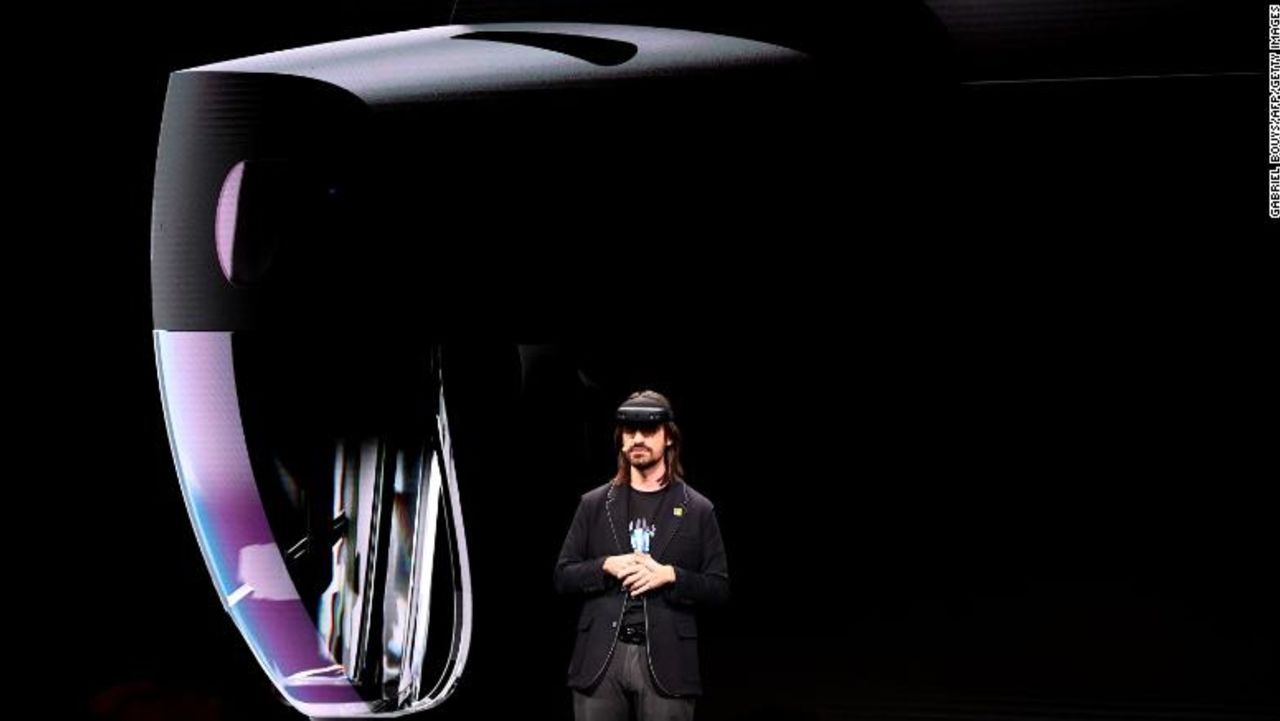 Microsoft's technical fellow Alex Kipman reveals "HoloLens 2" during a presentation at the Mobile World Congress (MWC) on the eve of the world's biggest mobile fair in Barcelona on February 24, 2019. - Phone makers will focus on foldable screens and the introduction of blazing fast 5G wireless networks at the world's biggest mobile fair starting tomorrow in Spain as they try to reverse a decline in sales of smartphones. (Photo by GABRIEL BOUYS / AFP)