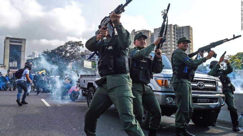 Militares venezolanos disparan gases lacrimógenos.