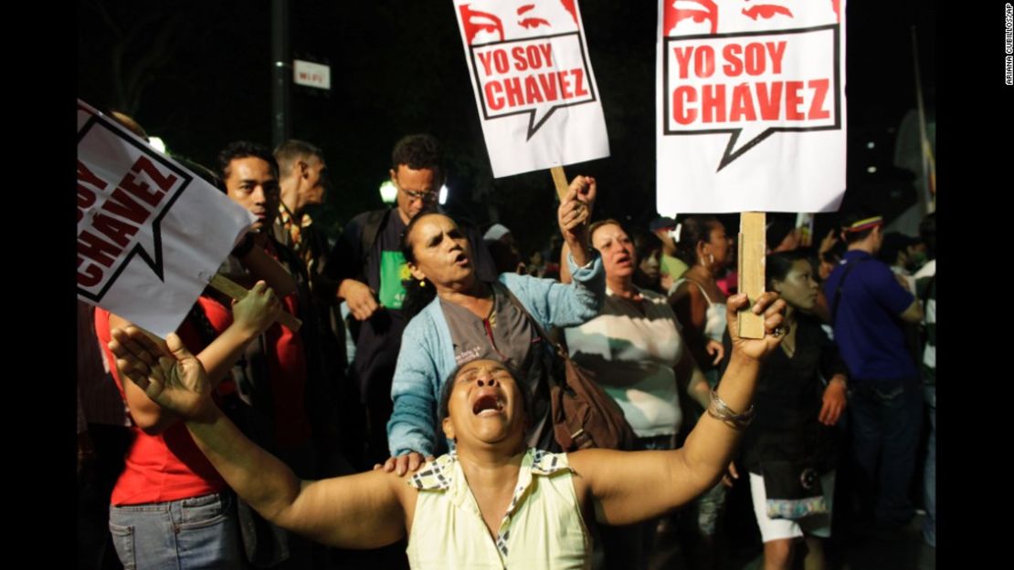 Una seguidora de Hugo Chávez llora mientras sostiene un cartel que dice "Yo soy Chávez" en la plaza Bolívar en Caracas, el 5 de marzo de 2013 cuando murió el presidente de Venezuela.