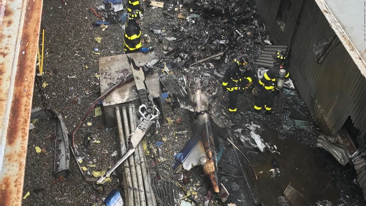 NEW YORK, NEW YORK - JUNE 10: In this handout photo provided by the New York City Fire Department, firefighters work on the roof of 787 Seventh Avenue at 51st Street after a helicopter crashed there on June 10, 2019 in New York City. One person, reportedly the pilot and only person on board, was killed.