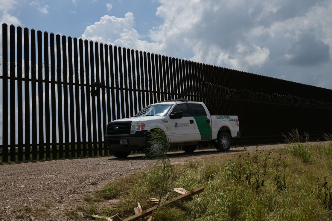 A US Border Patrol vehicle drives along a section of border fence near the US-Mexico border on June 12, 2019, in Hidalgo, Texas. (Photo by Loren ELLIOTT / AFP)