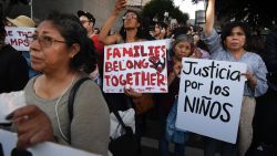 People protest against the upcoming ICE raids and detentions of refugee asylum seekers at a vigil outside the main ICE detention center (background) in downtown Los Angeles on July 12, 2019. - Numerous vigils were held across the US as part of the Lights for Liberty movement's campaign to call for an end to "inhumane conditions at the border" and the deportations of refugee asylum seekers. (Photo by Mark RALSTON / AFP)