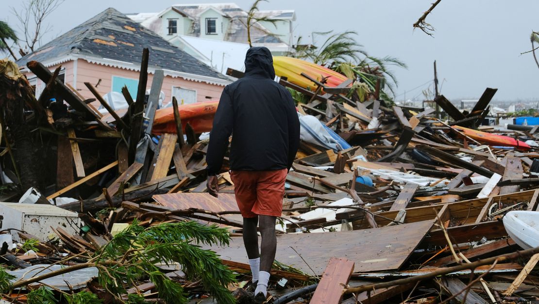 CNNE 699072 - a man walks through the rubble in the aftermath of hurricane dorian in marsh harbour