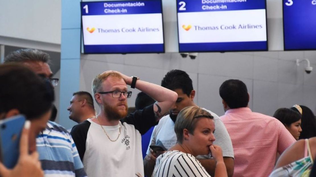 Pasajeros hacen fila en el mostrador cerrado de la agencia Thomas Cook en el aeropuerto de Cancún, México, el 23 de septiembre.