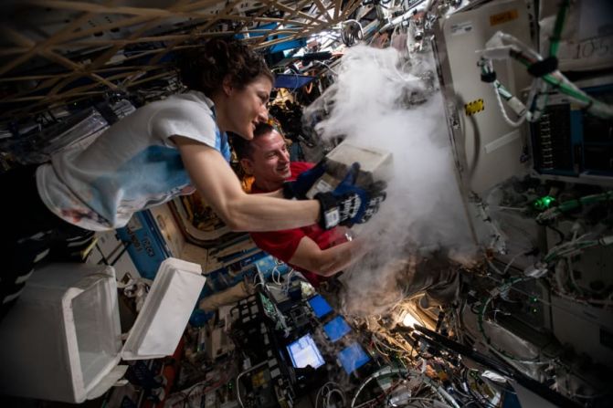 Los astronautas de la NASA Christina Koch y Andrew Morgan almacenan muestras de investigación en un congelador de ciencias dentro del módulo de laboratorio Destiny de EE. UU. Foto: NASA