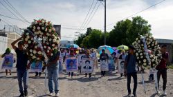 TOPSHOT - Relatives of the 43 missing students of the teaching training school of Ayotzinapa march with their portraits the day after of the fifth anniversary of their disappearance, in Iguala, Guerrero State, Mexico on September 27, 2019. - The Mexican prosecutor-general's office said -last September 18- it will reinvestigate "almost from scratch" the disappearance and suspected massacre of 43 students in 2014, a case that still haunts the country. (Photo by FRANCISCO ROBLES / AFP)