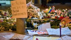 A person lights a candle outside the San Ignacio hospital as people keep a vigil for a demonstrator who was injured by a member of the Mobile Anti-Disturbance Squadron (ESMAD), during a national strike in Bogota, on November 25, 2019. (Photo by Raul ARBOLEDA / AFP)